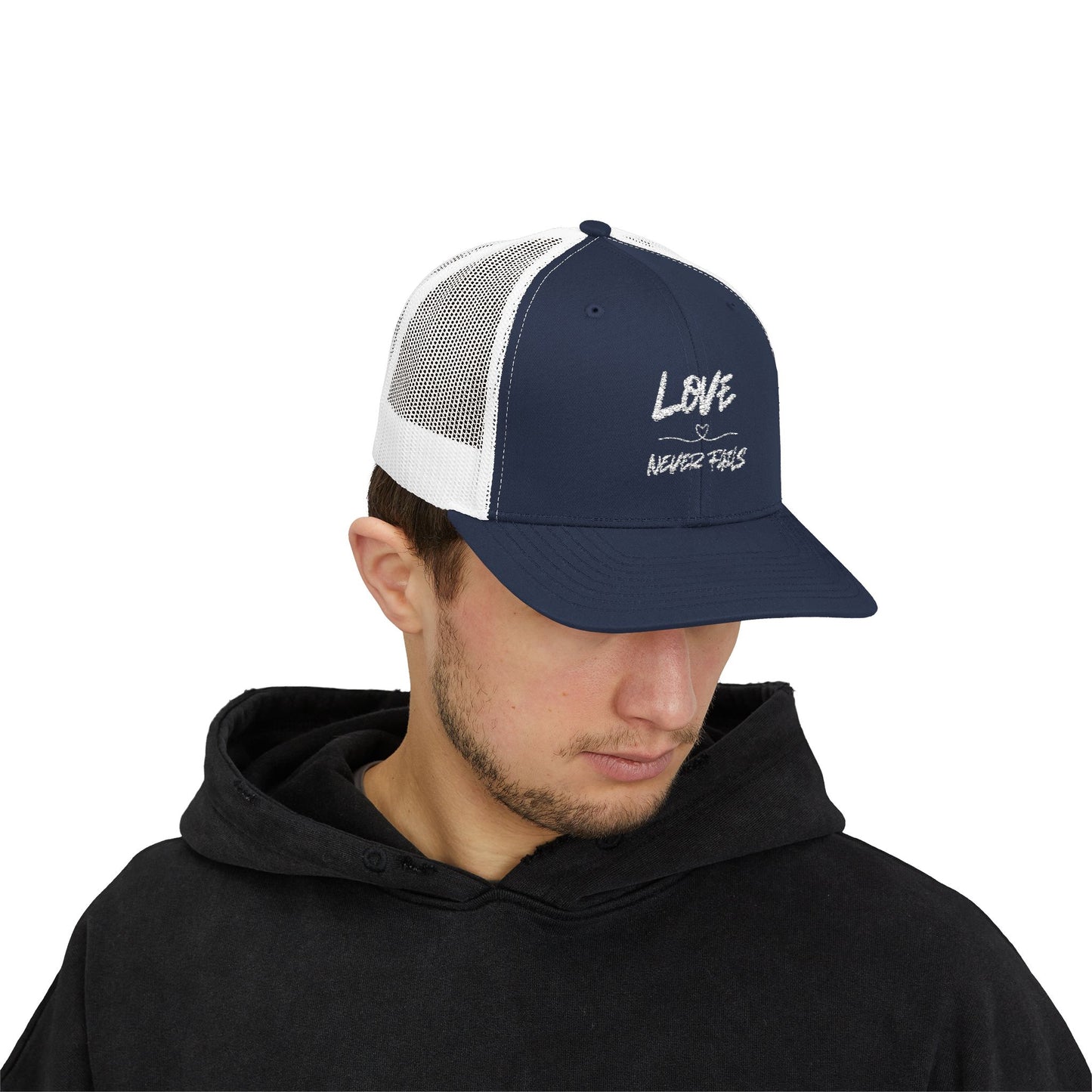 LOVE NEVER FAILS TRUCKER HAT
