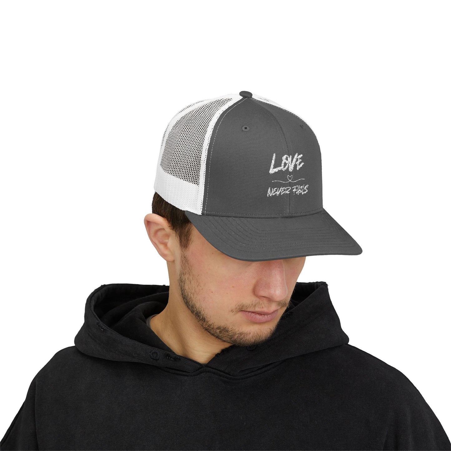 LOVE NEVER FAILS TRUCKER HAT