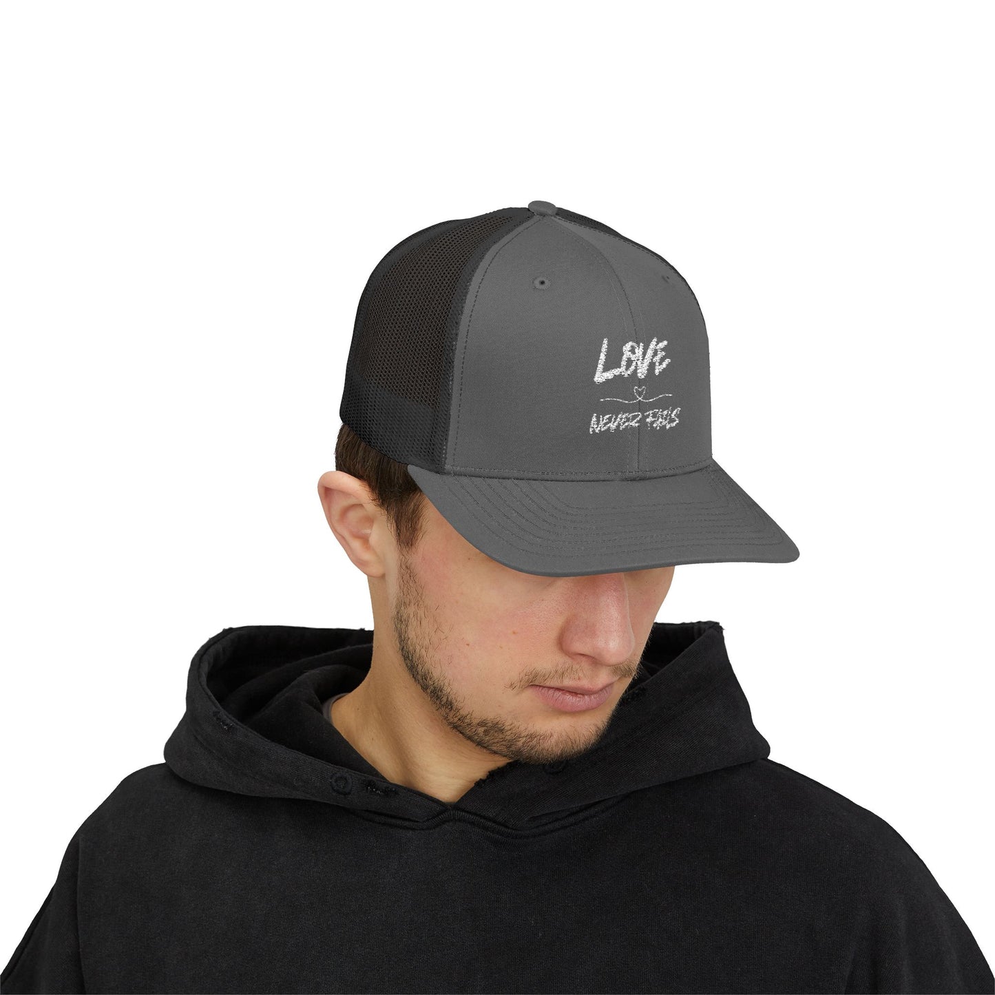 LOVE NEVER FAILS TRUCKER HAT
