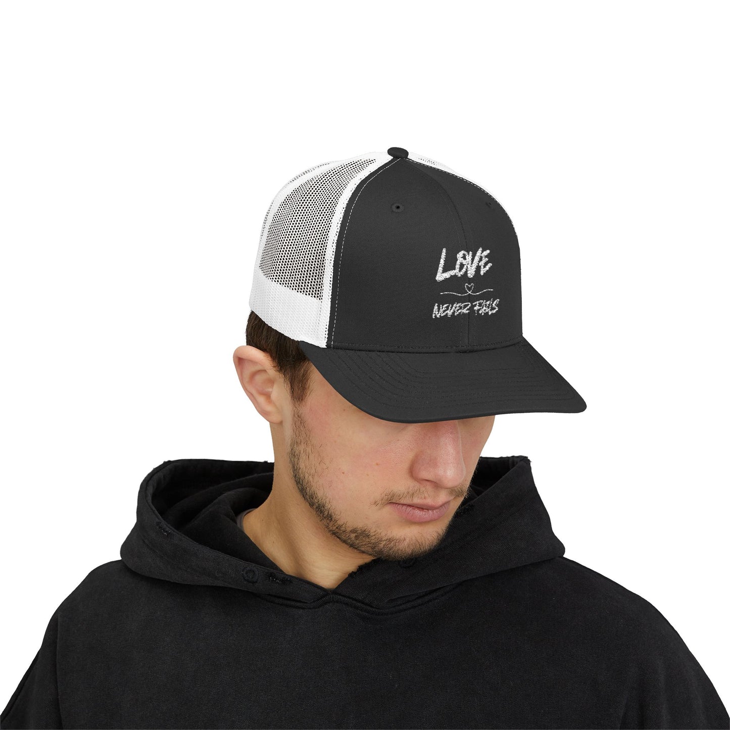 LOVE NEVER FAILS TRUCKER HAT