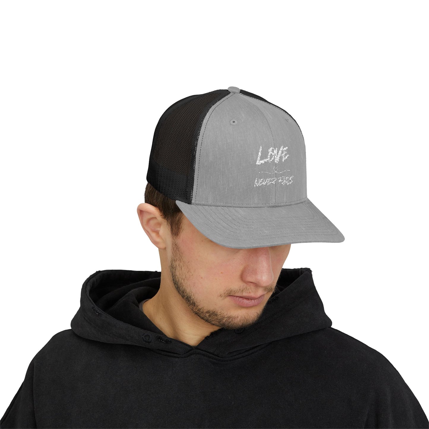 LOVE NEVER FAILS TRUCKER HAT